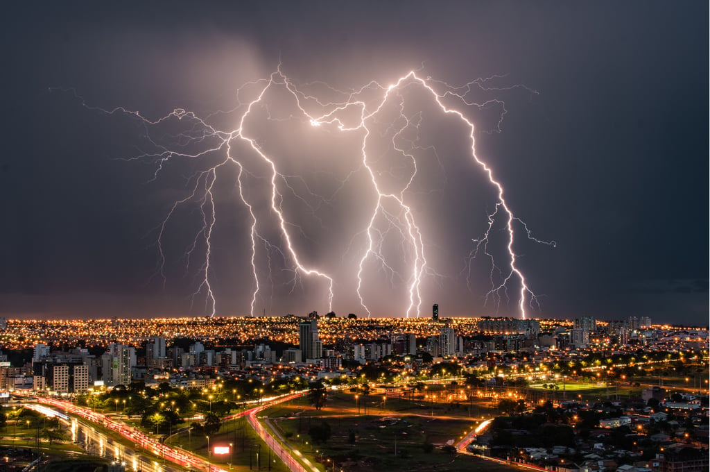 multiple lightning strikes city skyline